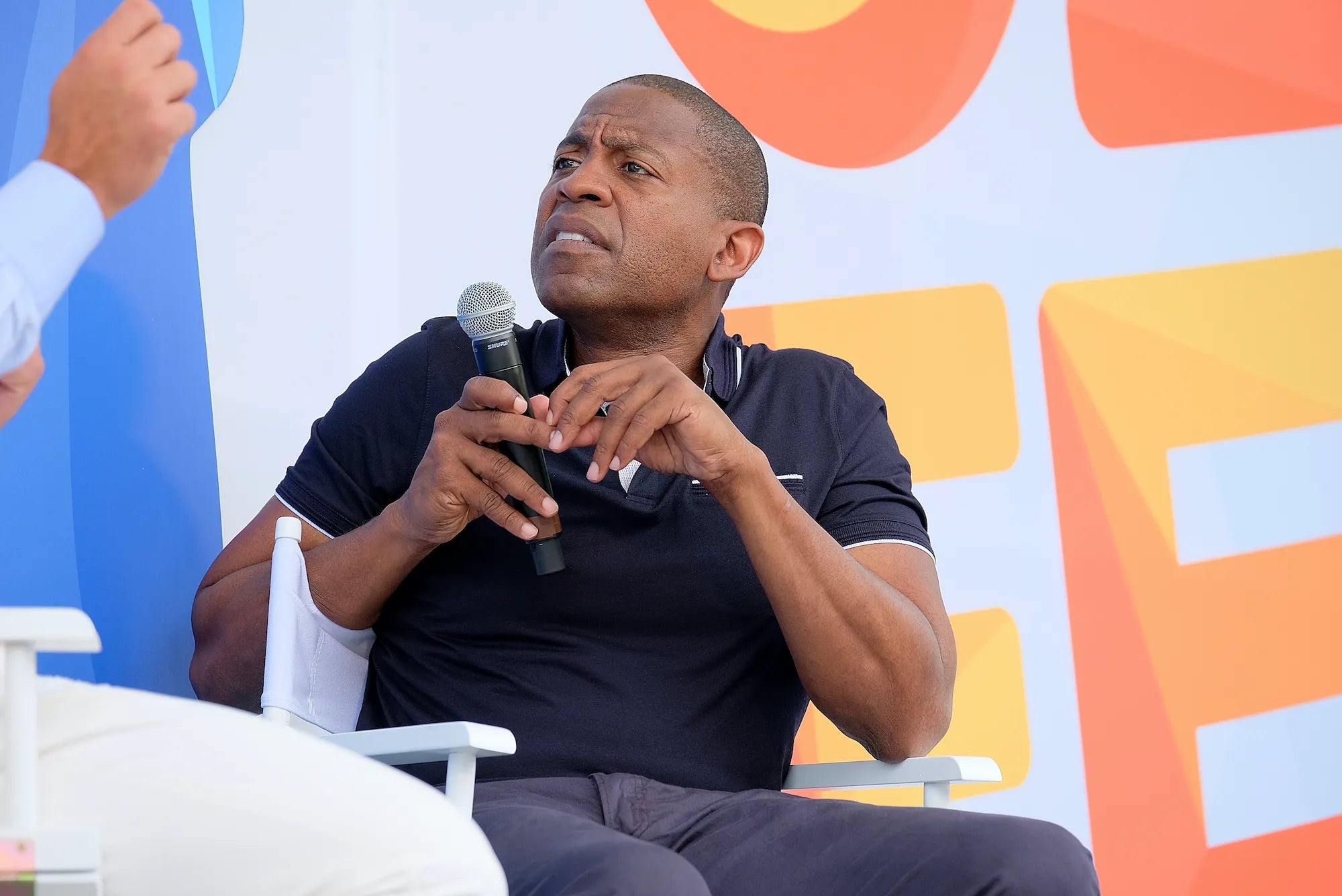 Carlos Watson speaking on stage at OZY Fest